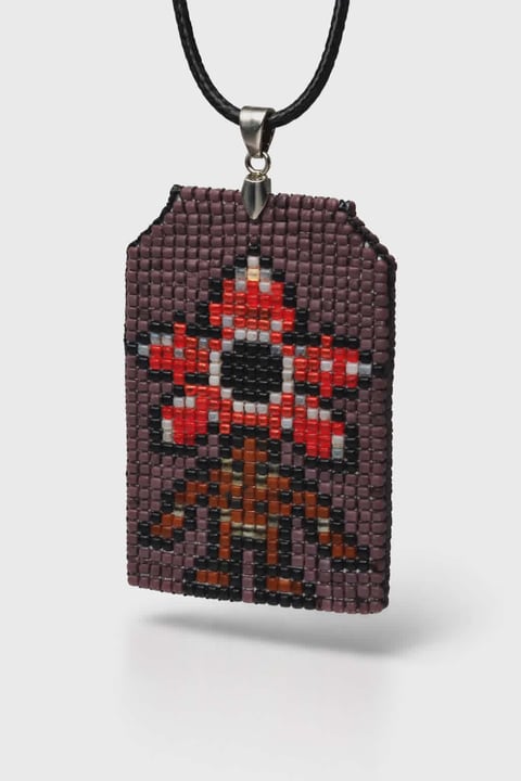 Beaded pendant necklace with pixel art mushroom design in red, white, black, and brown beads on black cord