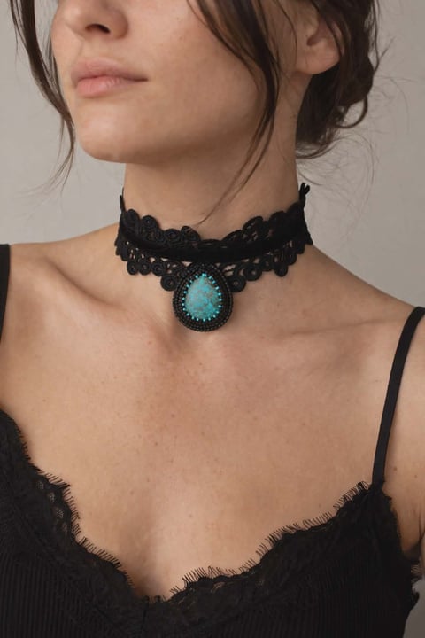 Woman wearing black lace choker with turquoise stone pendant and black lace top